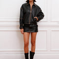 Campera Traf Sofia Sarkany negra de cuero oversize con pespuntes marrones, ideal para un look moderno de mujer.